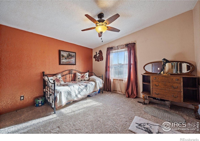 carpeted bedroom featuring lofted ceiling, ceiling fan, and a textured ceiling