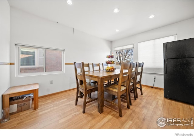 dining space with light hardwood / wood-style flooring