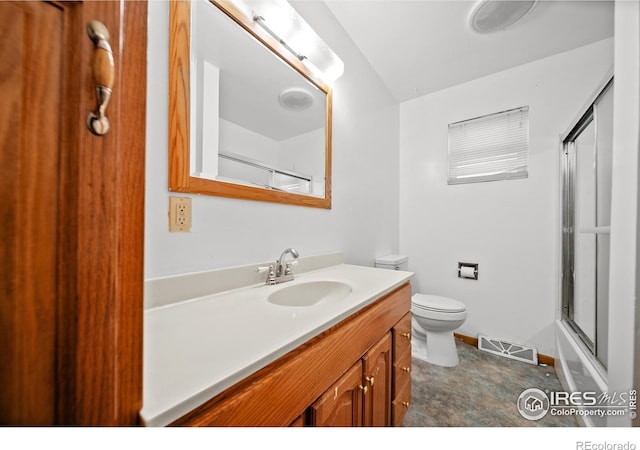 full bathroom featuring shower / bath combination with glass door, vanity, and toilet