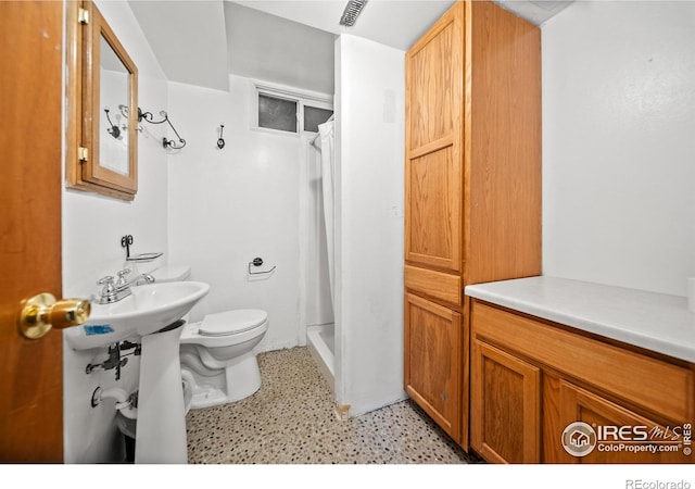 bathroom featuring toilet and walk in shower