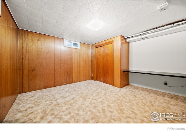 home theater room featuring carpet and wood walls