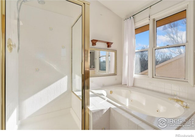 bathroom featuring vaulted ceiling and shower with separate bathtub