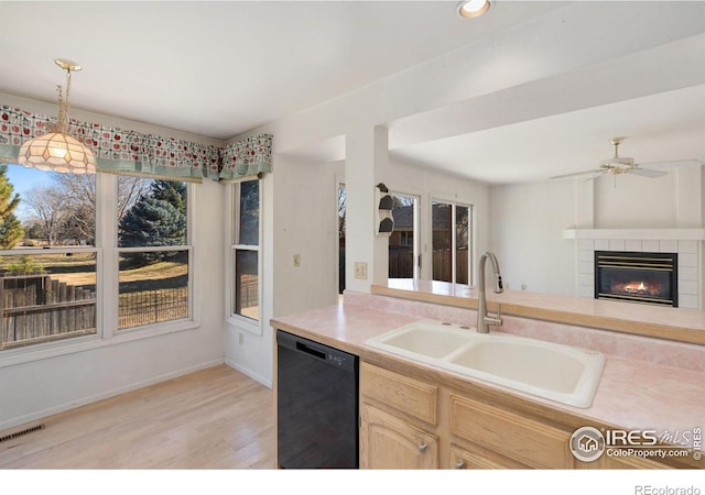 kitchen with pendant lighting, sink, ceiling fan, black dishwasher, and light brown cabinetry