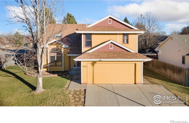 view of property featuring a front lawn and a garage