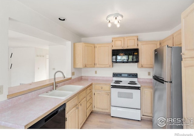 kitchen featuring light brown cabinetry, black appliances, sink, kitchen peninsula, and light wood-type flooring