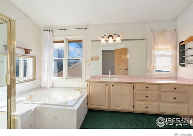 bathroom with a relaxing tiled tub and vanity