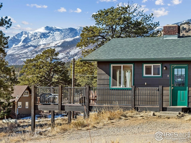 exterior space with a deck with mountain view