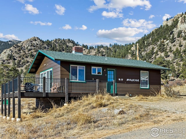 view of front of property featuring a deck with mountain view