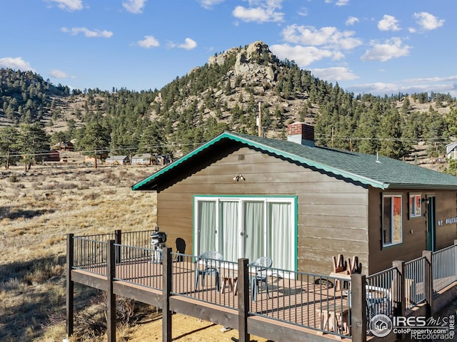 back of house featuring an outdoor structure and a mountain view