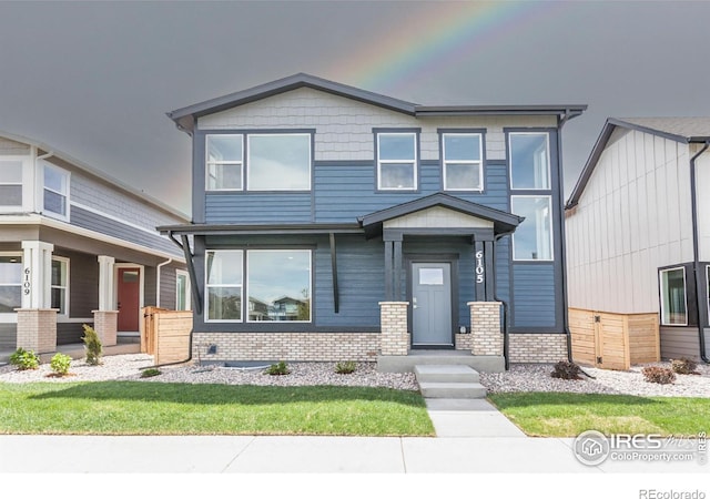 6105 Saddle Horn Dr, Timnath, CO 80547 - view of front of property featuring brick siding and a front lawn
