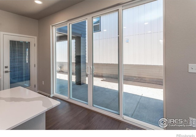 6105 Saddle Horn Dr, Timnath, CO 80547 - doorway with dark wood-style floors and recessed lighting