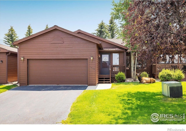 view of front of home with a front yard and a garage