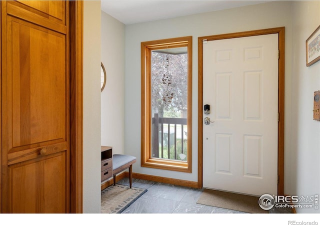 tiled foyer with a healthy amount of sunlight