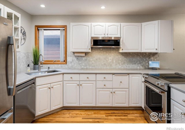 kitchen with white cabinetry, sink, and appliances with stainless steel finishes