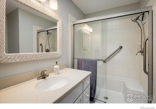 bathroom with vanity and a shower with shower door