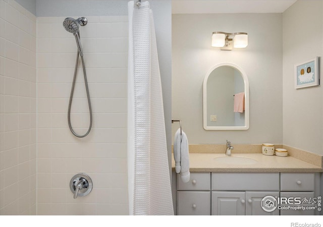 bathroom featuring curtained shower and vanity