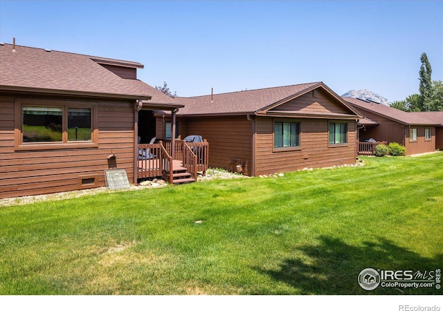 rear view of property with a lawn