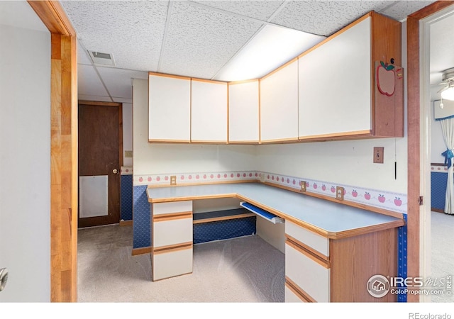 unfurnished office with light colored carpet and a drop ceiling