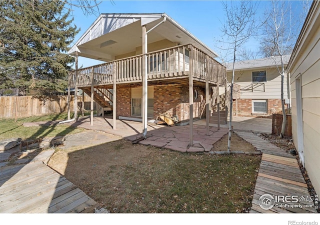 rear view of property with a patio and a deck