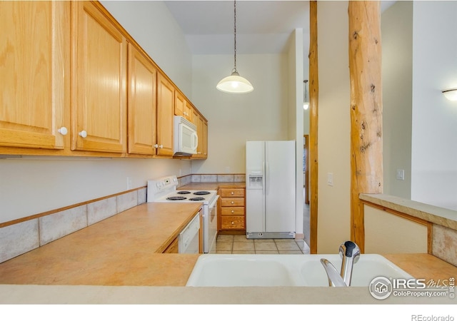 kitchen featuring sink, light brown cabinets, decorative light fixtures, white appliances, and light tile patterned floors