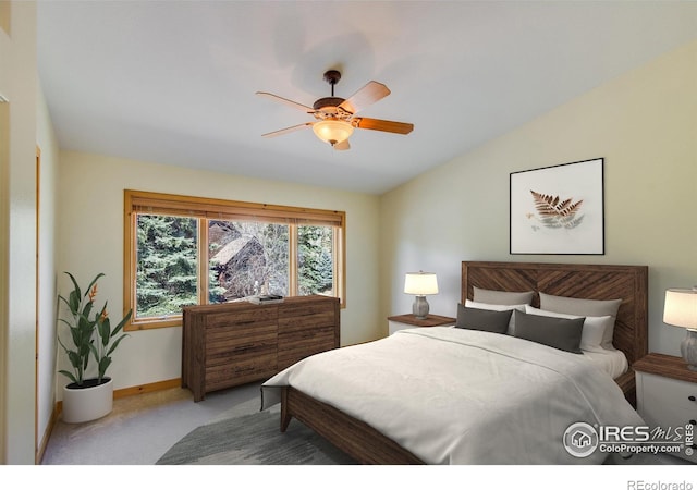 bedroom with light colored carpet, vaulted ceiling, and ceiling fan