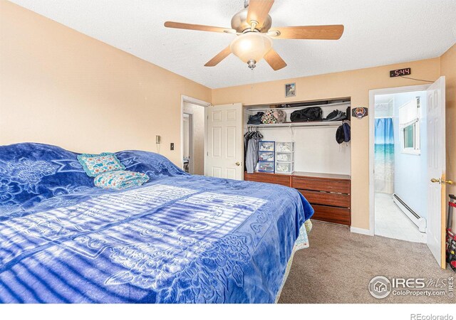 carpeted bedroom featuring ceiling fan, a closet, baseboard heating, and a textured ceiling