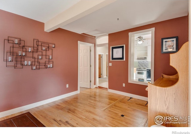 interior space with beam ceiling and wood-type flooring