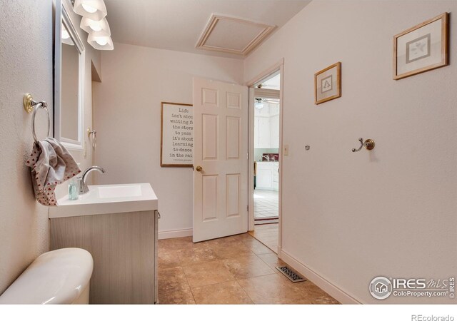 bathroom with tile patterned floors, vanity, and toilet