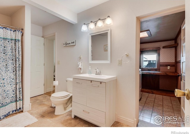 bathroom featuring tile patterned flooring, vanity, and toilet