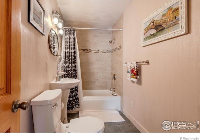 bathroom featuring toilet, tile patterned floors, and shower / tub combo with curtain