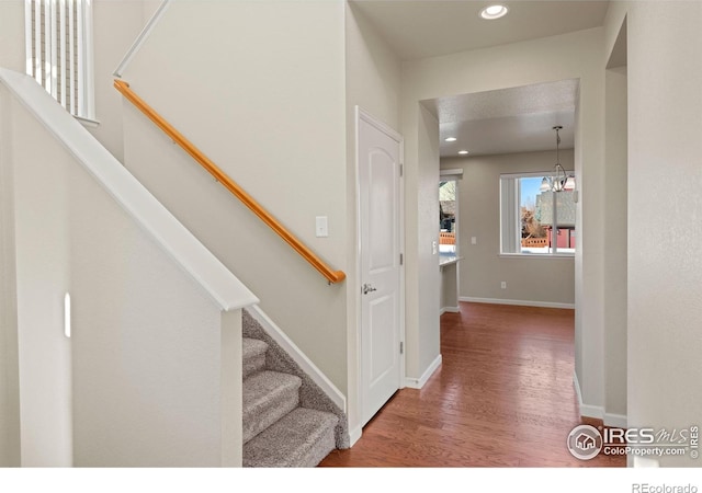 interior space featuring hardwood / wood-style floors and a notable chandelier