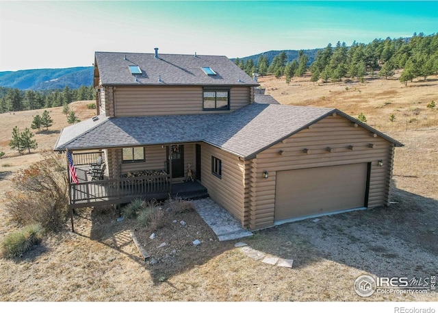 580 Saddle Notch Rd, Loveland, CO 80537 - log cabin featuring a mountain view, log siding, dirt driveway, and a shingled roof