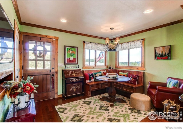 580 Saddle Notch Rd, Loveland, CO 80537 - dining room with ornamental molding, a chandelier, dark wood-type flooring, and a wainscoted wall