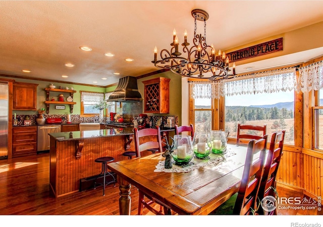580 Saddle Notch Rd, Loveland, CO 80537 - dining area featuring hardwood / wood-style floors, a chandelier, recessed lighting, a mountain view, and crown molding