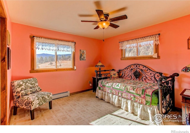 580 Saddle Notch Rd, Loveland, CO 80537 - bedroom featuring a baseboard radiator, multiple windows, ceiling fan, and carpet floors
