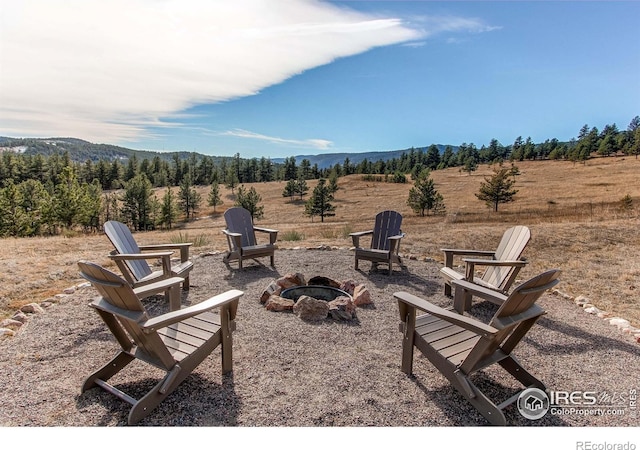 580 Saddle Notch Rd, Loveland, CO 80537 - view of patio featuring a fire pit, a mountain view, and a rural view