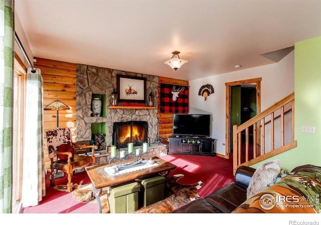 580 Saddle Notch Rd, Loveland, CO 80537 - carpeted living room featuring a fireplace, rustic walls, and stairs