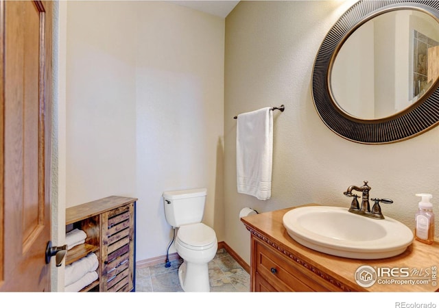 bathroom with tile patterned floors, vanity, and toilet