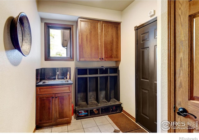 mudroom with light tile patterned floors and sink