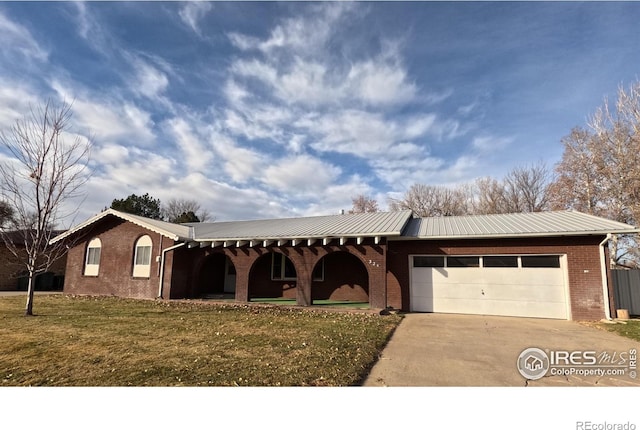 ranch-style home featuring a garage and a front yard