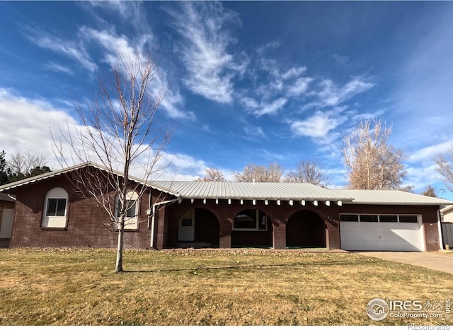 ranch-style house with a garage and a front lawn