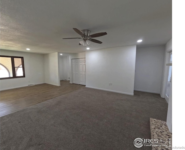 carpeted spare room with ceiling fan