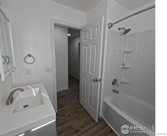 bathroom featuring wood-type flooring, bathing tub / shower combination, and vanity