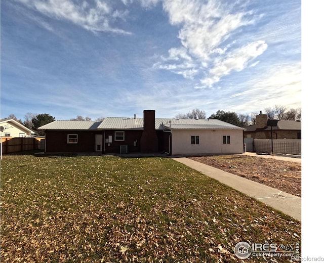 rear view of property with a yard