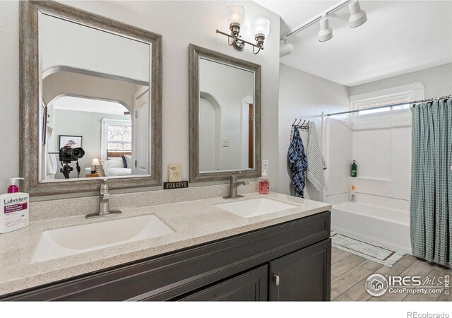 2981 W 144th Ave, Broomfield, CO 80023 - ensuite bathroom featuring healthy amount of natural light, rail lighting, double vanity, and shower / bath combination with curtain