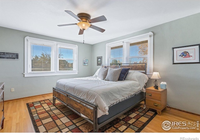 2981 W 144th Ave, Broomfield, CO 80023 - bedroom with multiple windows, wood finished floors, baseboards, and ceiling fan
