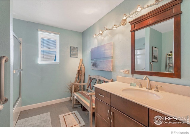 bathroom with tile patterned flooring, vanity, and bath / shower combo with glass door