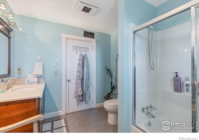 full bathroom featuring tile patterned flooring, vanity, toilet, and enclosed tub / shower combo