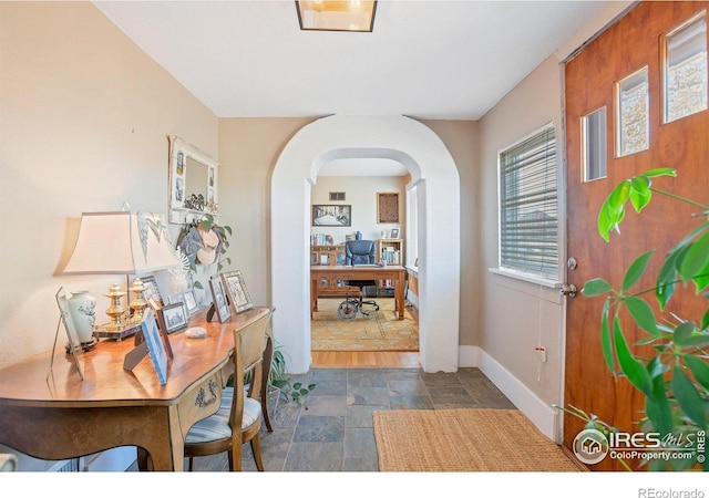 2981 W 144th Ave, Broomfield, CO 80023 - foyer featuring stone tile flooring, arched walkways, and baseboards