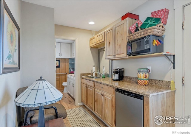 kitchen with sink, stainless steel dishwasher, light brown cabinetry, light hardwood / wood-style floors, and light stone counters